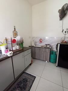 a kitchen with a counter and a microwave in it at De'Bendang Homestay Pendang in Pendang