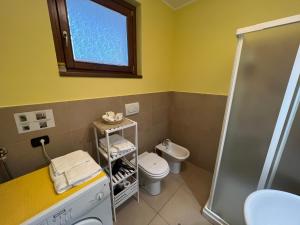 a bathroom with a toilet and a shower at Belvedere in Costa - Lake View in Bellano