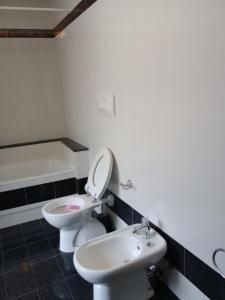 a bathroom with a toilet and a sink at La Fontanella in Spello +9 photos