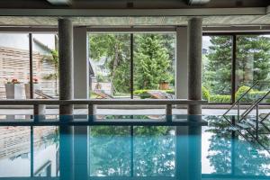 a swimming pool with a view of a house at Nationalpark Lodge Grossglockner in Heiligenblut