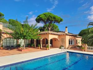 a house with a swimming pool in front of it at La Casa Celestial in Platja d'Aro