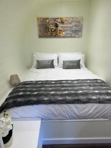 a bedroom with a large white bed in a room at South Black Hill in Penicuik