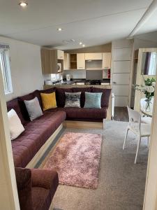 a living room with a couch and a kitchen at 3 bedroom luxury caravan haven, marton mere in Blackpool