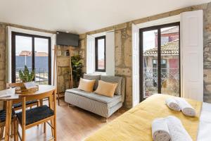 - une chambre avec un lit, une table et une chaise dans l'établissement GuestReady - Estadia agradável perto dos Clérigos, à Porto