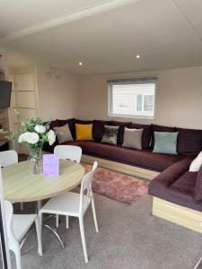 a living room with a couch and a table at 3 bedroom luxury caravan haven, marton mere in Blackpool