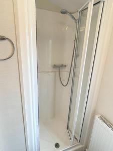 a shower with a glass door in a bathroom at 3 bedroom luxury caravan haven, marton mere in Blackpool