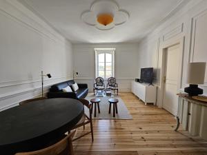 a living room with a couch and a table at Sintra Clássica in Sintra