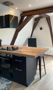 a kitchen with a wooden counter top and a table at Vue sur la cathédrale - Au cœur de Bourges in Bourges