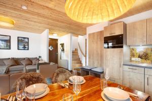 a dining room with a table and a living room at Bergchalet 20 in Diemelsee