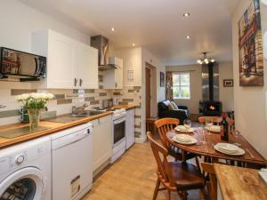 uma cozinha com uma mesa e uma sala de jantar em Meadow View em Mold