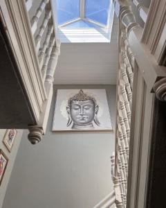 a picture of a head on a wall with a skylight at The Boho - 4 min walk to beach & town in Bournemouth