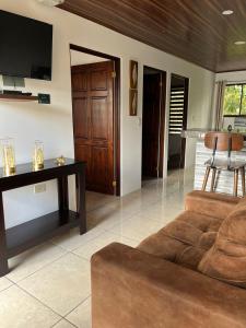 a living room with a couch and a tv at Mevak Apartments Suites in Fortuna