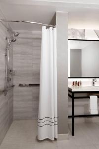 a bathroom with a shower curtain and a sink at New York Marriott Downtown in New York