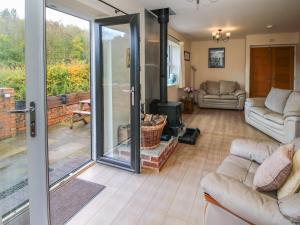 a living room with a sliding glass door at Alyn View in Llanferres