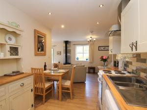 a kitchen with a table and a dining room at Alyn View in Llanferres