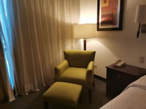 a hotel room with a chair and a lamp at Holiday Inn Monterrey Valle, an IHG Hotel in Monterrey