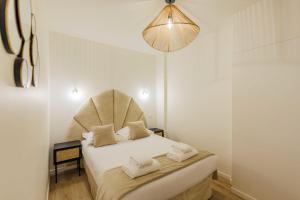 um quarto com uma cama com duas toalhas em Charming Apartment 6Pax in Vibrant Rue d'Hauteville em Paris