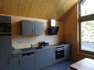 a kitchen with a sink and a stove at Alte Tischlerei Engelsbach in Georgenthal