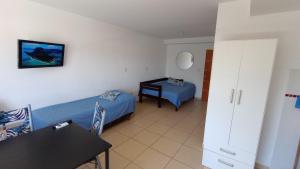 a room with two beds and a table in it at El Depto de Roberto in Villa María