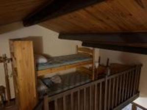 a room with a crib in a house at Le Colombera - Ideal pour sportif in Tende +2 photos