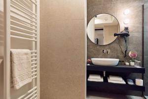 a bathroom with a sink and a mirror at The Hotel Ljubljana in Ljubljana +52 photos
