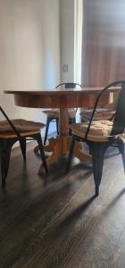 a wooden table with a chair and a bench at Departamento 2d1b Puerto Varas in Puerto Varas