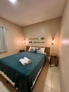 um quarto com uma cama com duas toalhas em RECANTO DAS ÁGUAS VILLE em Santo Amaro