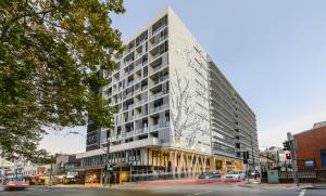 a tall white building on a city street at 2 beds luxury apartment in the heart of chatswood12 in Sydney
