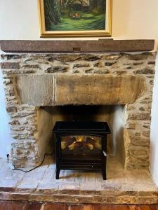 a stone fireplace with a fire place in a room at The Trinity Cottage in Manayunk, Walk to Main Street and Train in Philadelphia