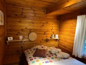 a bedroom with a bed in a log cabin at Jolie chambre dans chalet in Le Vaud