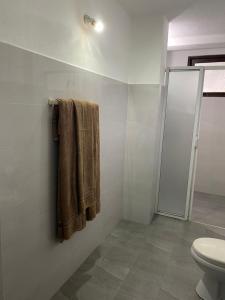 a bathroom with a toilet and a towel at Unawatuna Beach Bungalow - in Unawatuna +37 photos