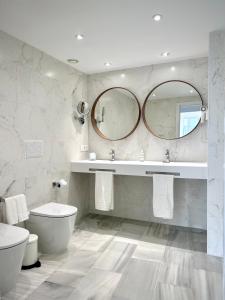 a bathroom with a sink and a toilet and a mirror at SMILE CAVANA APARTMENTS in Nerja