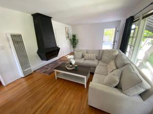 a living room with a couch and a table at Lovely 2BR Home with Fireplace and Patio in Culver in Los Angeles