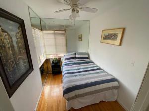 a bed in a room with a ceiling fan at Lovely 2BR Home with Fireplace and Patio in Culver in Los Angeles