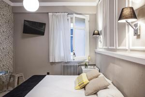 a hotel room with a bed and a window at AinB B&B Eixample-Muntaner in Barcelona
