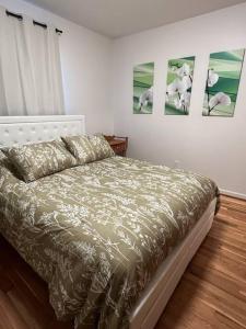 a bedroom with a bed and two pictures on the wall at Cozy two bedroom home near downtown KC in Merriam