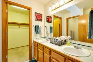 a bathroom with two sinks and a large mirror at Milwaukie Home with Covered Porch Dogs Welcome! in Milwaukie +17 photos