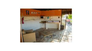 a living room with a table and a couch and a table at Vila Velluti Hotel in Samambaia