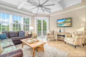 a living room with a couch and a tv at The Key Canal - 455 in Siesta Key