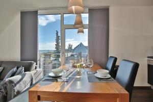 a dining room with a table and a large window at Haus Meeresrauschen Haus Meeresrauschen Appartement 1 6 in Haffkrug