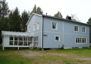 a large blue house with a lot of windows at Overkalix Holiday Home with Sauna in Jock