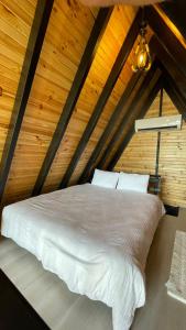 a bedroom with a white bed in a attic at Irmak Vadi Bungalov Zonguldak 