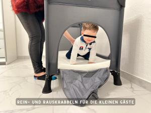 a baby is sitting in a baby carriage at Suite Lombardi - Terrasse, Babybett, Doppelbett, Waschmaschine, Ruhige Lage in Bieber