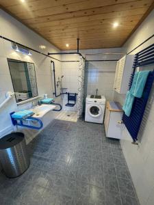 a bathroom with a sink and a washing machine at Ferienwohnung Jank in Jenig