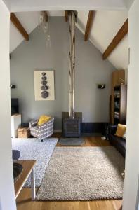 a living room with a fireplace and a couch at Eakie House Apartments - Kinlochleven in Kinlochleven