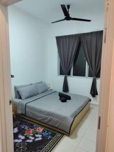 a bedroom with a bed with a black cat sitting on it at Lakeview 3 Bedroom Apartment in Presint 18 Putrajaya in Putrajaya