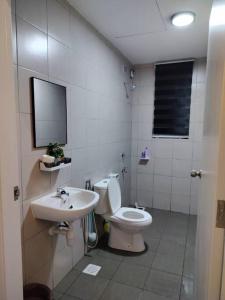 a bathroom with a toilet and a sink at Lakeview 3 Bedroom Apartment in Presint 18 Putrajaya in Putrajaya