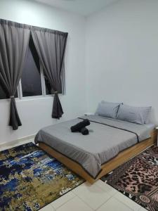 a teddy bear sitting on a bed in a bedroom at Lakeview 3 Bedroom Apartment in Presint 18 Putrajaya in Putrajaya