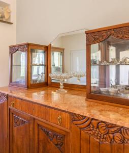 a bathroom with wooden cabinets and a large mirror at Jasmine house in Sitia