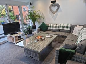 a living room with a couch and a table at Dungarvon House B&B, Exclusive Bookings Only, Hot tub, Garden & Summerhouse, EV Point in Weston-super-Mare